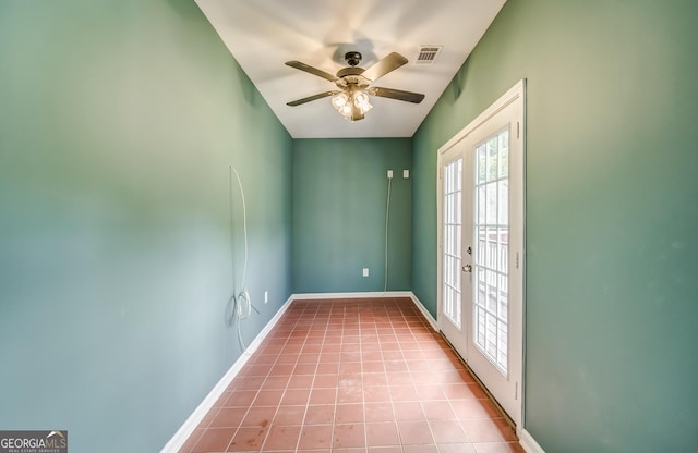 unfurnished room featuring tile patterned flooring, visible vents, a ceiling fan, and baseboards