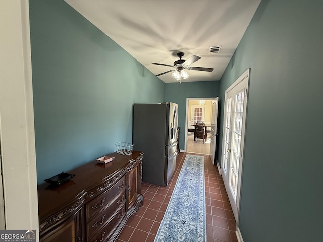 corridor with dark tile patterned flooring and visible vents