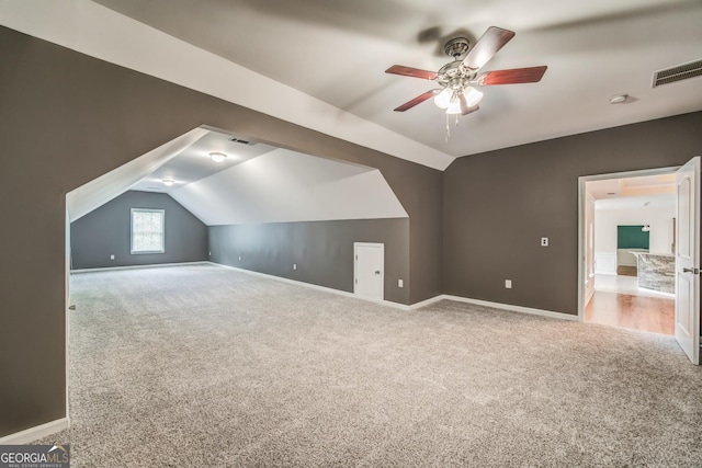 bonus room with vaulted ceiling, baseboards, visible vents, ceiling fan, and carpet floors