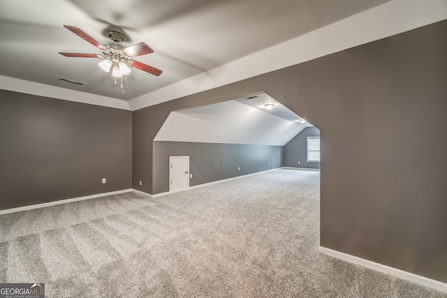 additional living space with baseboards, visible vents, lofted ceiling, a ceiling fan, and carpet floors