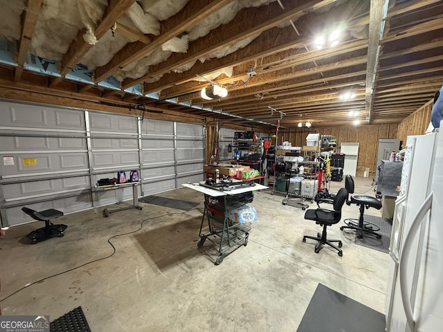 garage with freestanding refrigerator and a garage door opener