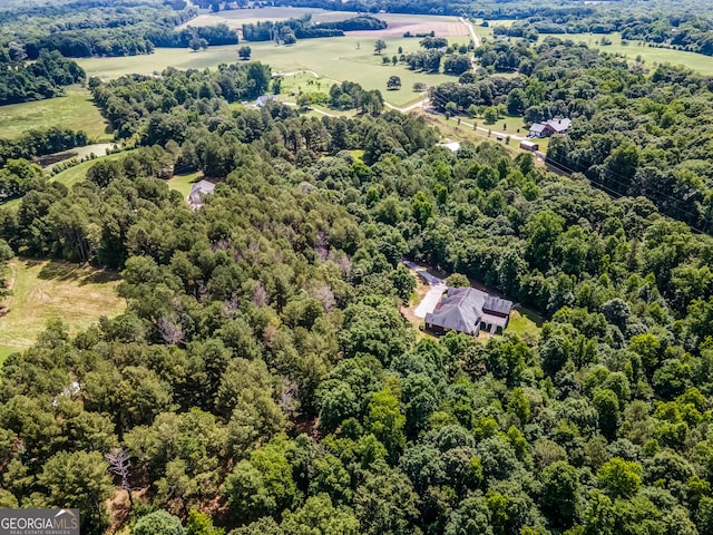 birds eye view of property with a wooded view