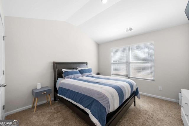 bedroom featuring baseboards, lofted ceiling, carpet floors, and visible vents