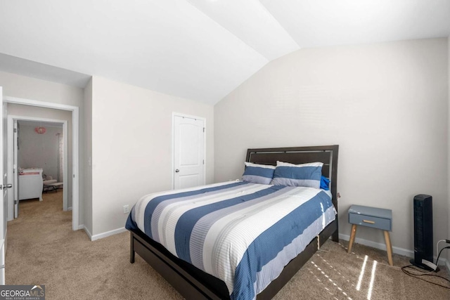 bedroom featuring lofted ceiling, baseboards, and light carpet