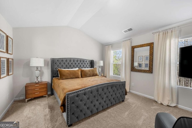 bedroom with baseboards, visible vents, carpet floors, and lofted ceiling