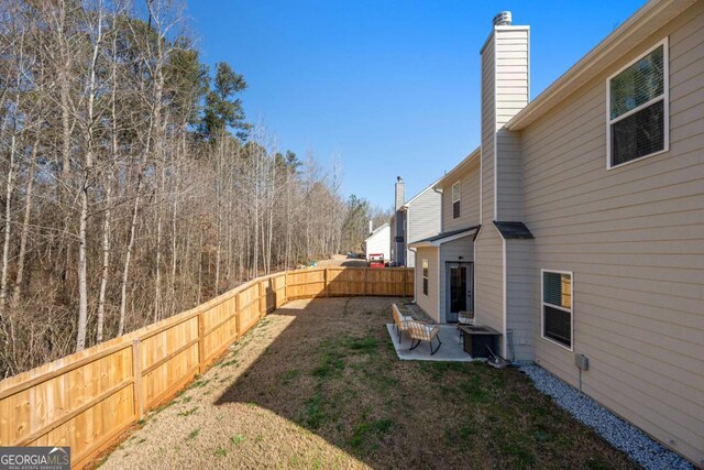 view of yard featuring a fenced backyard and a patio area