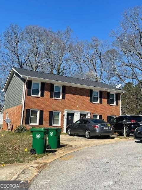 exterior space featuring brick siding