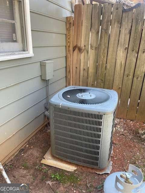 exterior details with central AC and fence