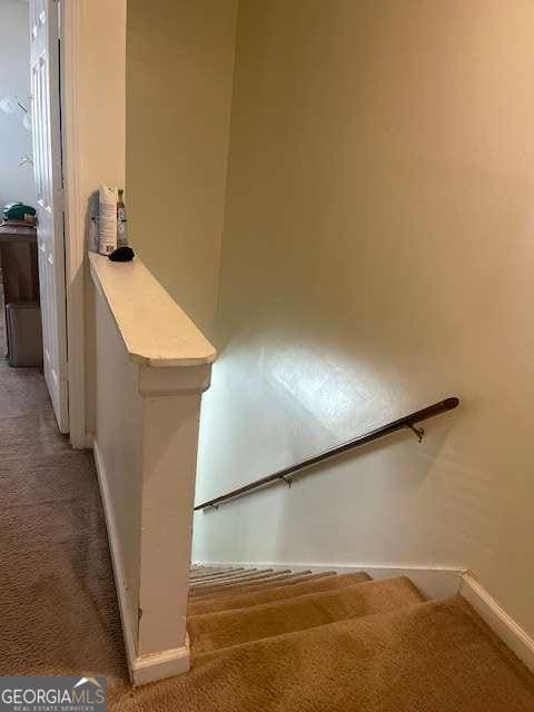 stairs with carpet flooring and baseboards