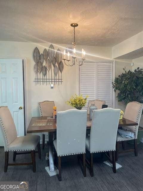 dining area featuring a notable chandelier and wood finished floors