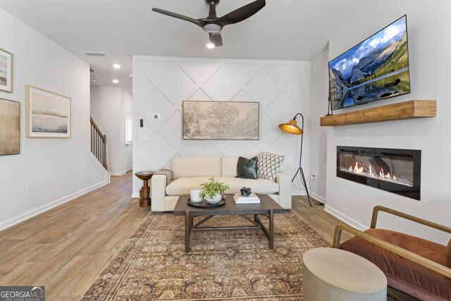233 Ivey Ter Unit 39, Temple, GA 30179 - living area featuring wood finished floors, a ceiling fan, a glass covered fireplace, baseboards, and recessed lighting
