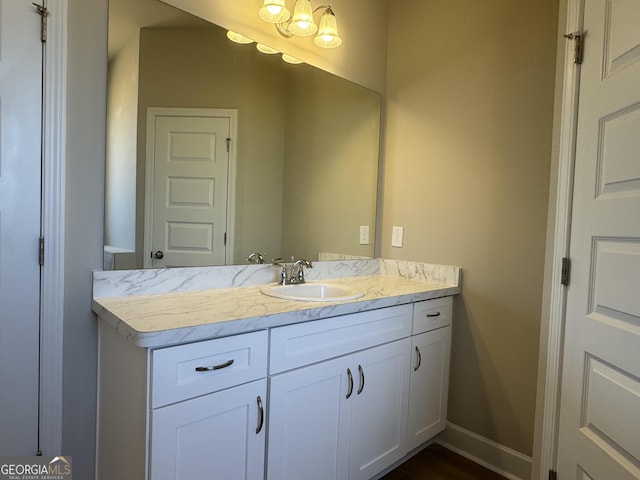 bathroom with vanity and baseboards