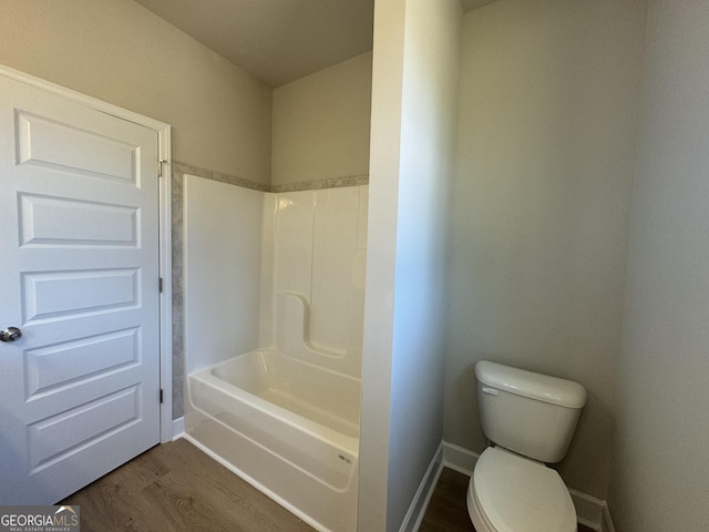 full bathroom featuring baseboards, toilet, and wood finished floors