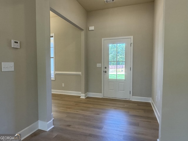 entrance foyer with visible vents, baseboards, and dark wood-style flooring