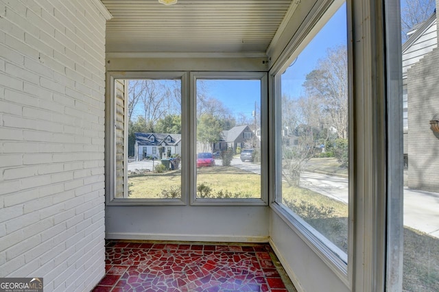 unfurnished sunroom featuring a wealth of natural light