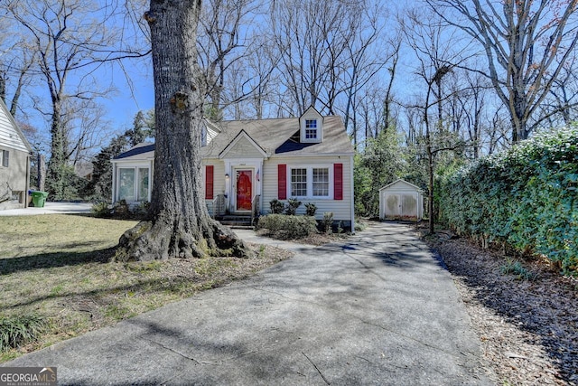 cape cod house with an outbuilding