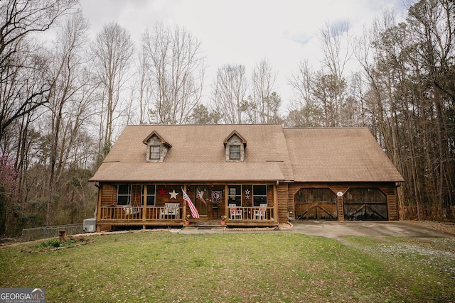 view of front facade with a front lawn, concrete driveway, a garage, and roof with shingles