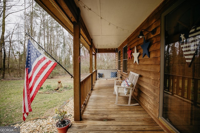 wooden terrace featuring covered porch