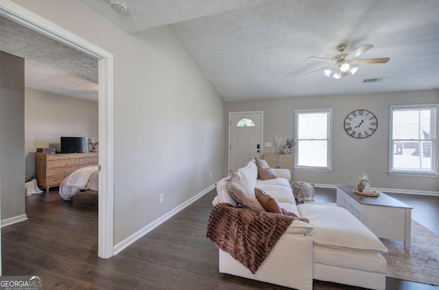 living room with visible vents, plenty of natural light, and dark wood-style floors