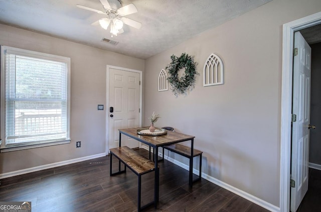 dining area with visible vents, baseboards, dark wood finished floors, and a ceiling fan