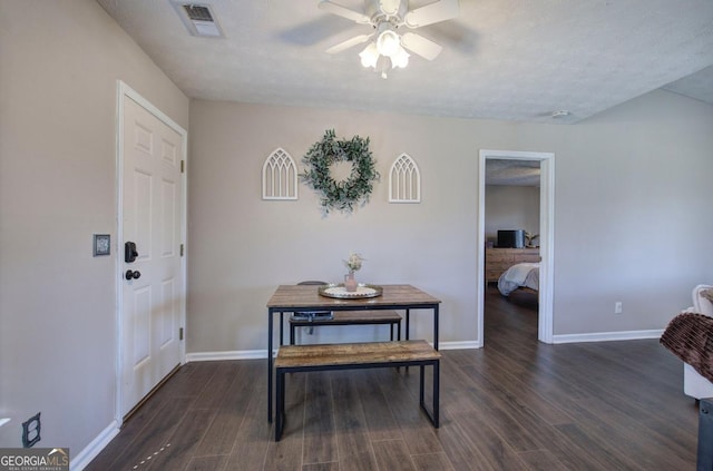 dining room with dark wood finished floors, baseboards, visible vents, and a ceiling fan