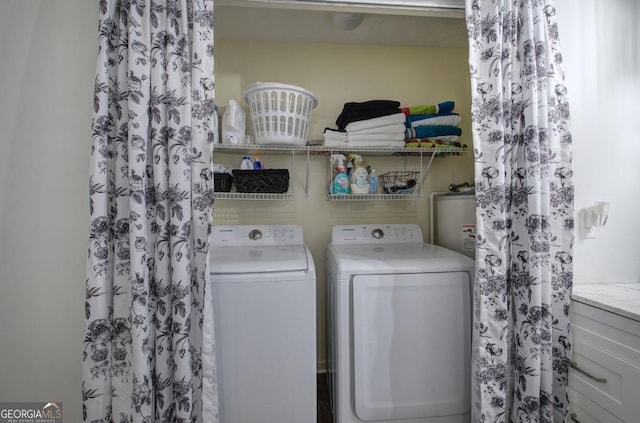 clothes washing area with water heater, laundry area, and separate washer and dryer