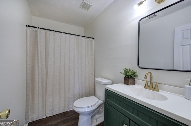 full bathroom featuring visible vents, toilet, wood finished floors, and vanity