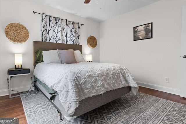 bedroom with ceiling fan, baseboards, and wood finished floors