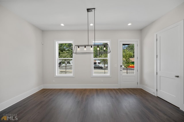 unfurnished dining area featuring a wealth of natural light, baseboards, dark wood-type flooring, and recessed lighting