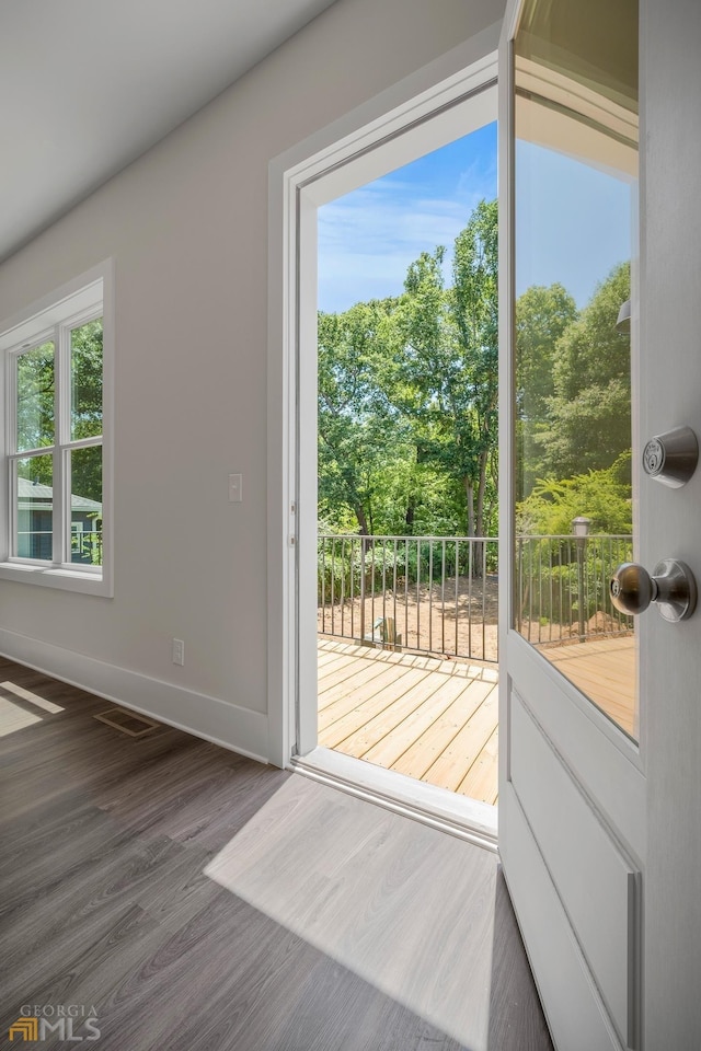 doorway to outside with baseboards and wood finished floors