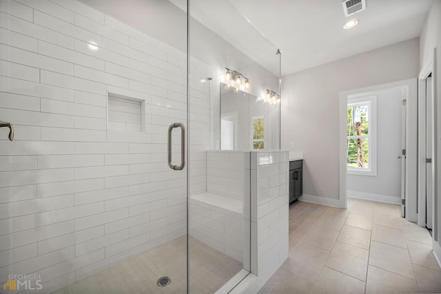 bathroom featuring vanity, baseboards, visible vents, a stall shower, and tile patterned flooring