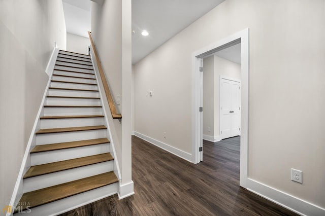 stairway with recessed lighting, wood finished floors, and baseboards