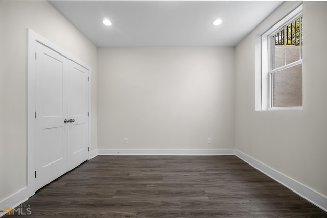 unfurnished room with recessed lighting, baseboards, and dark wood-style flooring