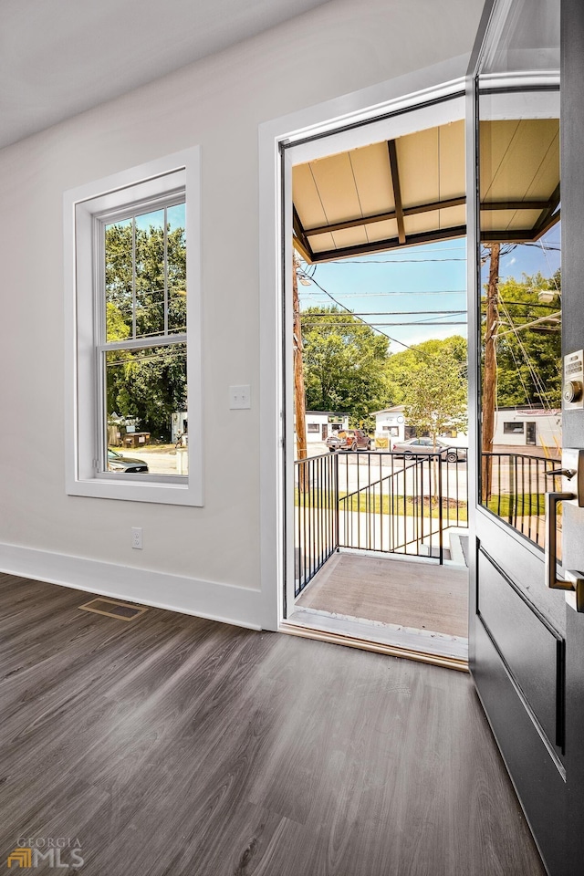 entryway with visible vents, baseboards, and wood finished floors