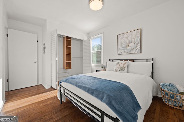 bedroom featuring wood finished floors and a closet