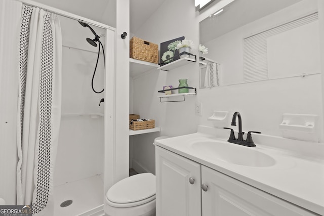 bathroom with vanity, toilet, and a stall shower