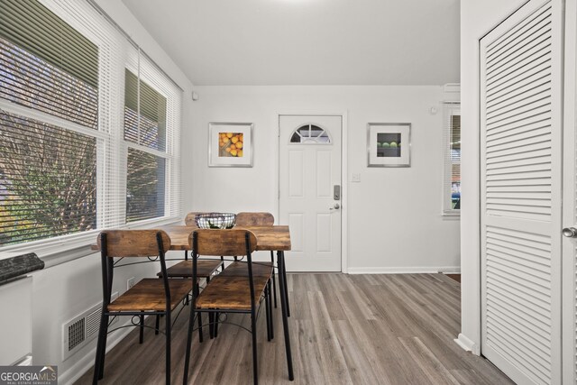 dining space featuring baseboards and wood finished floors