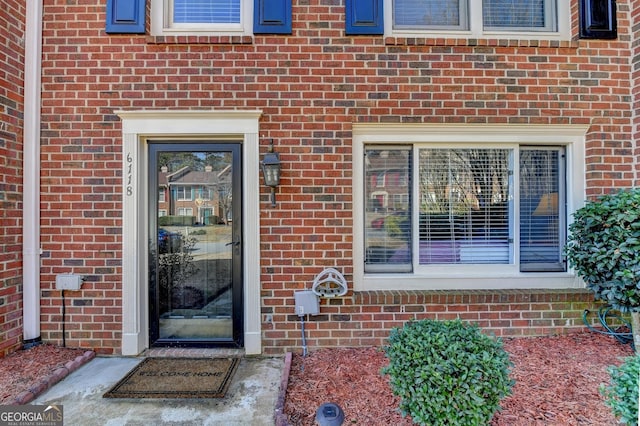 property entrance with brick siding