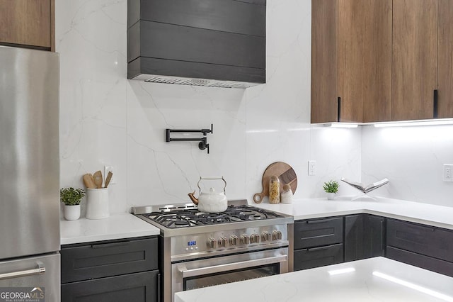 kitchen with backsplash, stainless steel appliances, and light countertops