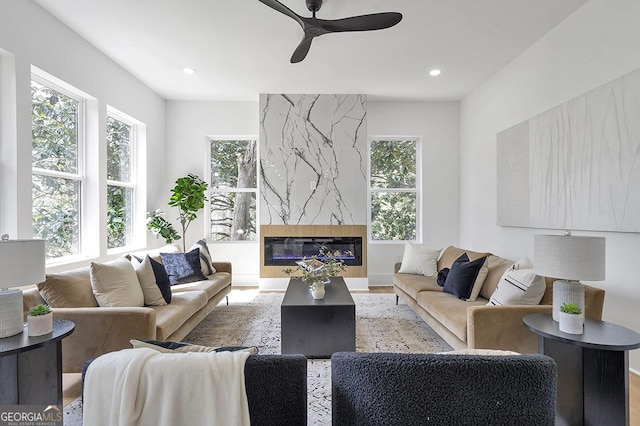 living area featuring a fireplace, recessed lighting, and ceiling fan