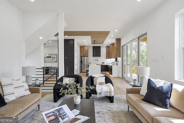 living area with recessed lighting and light wood-style flooring