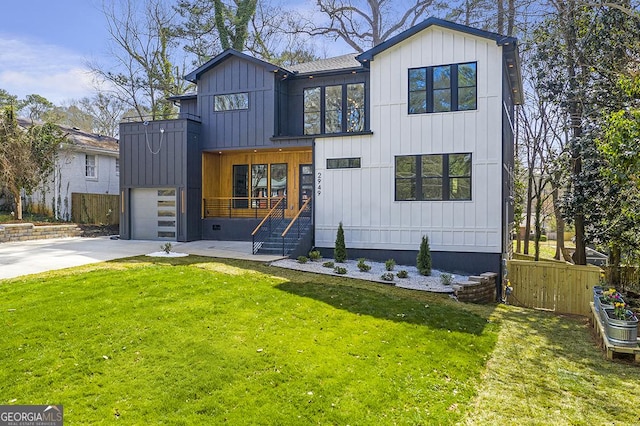 modern inspired farmhouse featuring board and batten siding, a front lawn, fence, driveway, and an attached garage