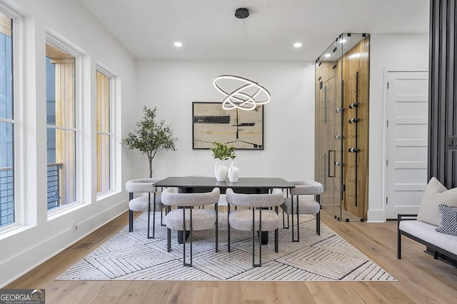 dining room featuring recessed lighting, baseboards, light wood-style floors, and a healthy amount of sunlight