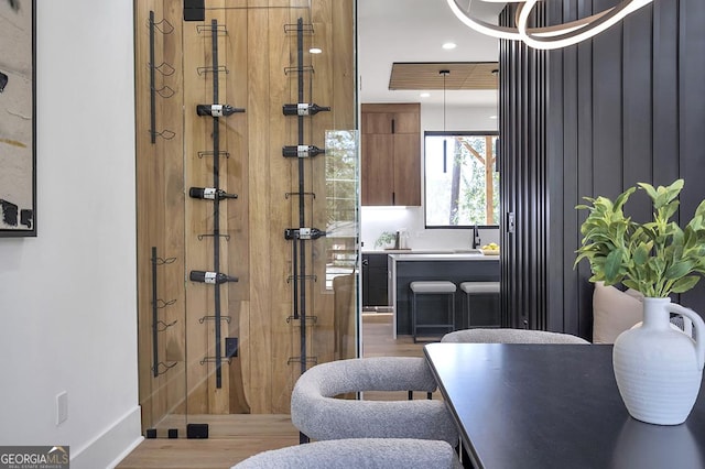 full bath featuring recessed lighting, wood finished floors, a stall shower, and a sink