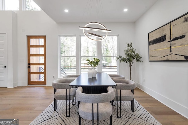 dining space featuring light wood-style flooring, recessed lighting, and baseboards