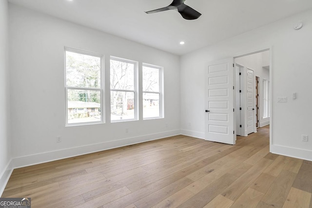 empty room with light wood finished floors, recessed lighting, baseboards, and ceiling fan