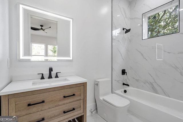 bathroom with vanity, toilet, marble finish floor, and a wealth of natural light