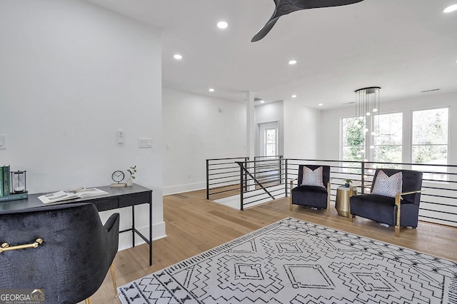 living area featuring recessed lighting, an upstairs landing, wood finished floors, and a ceiling fan