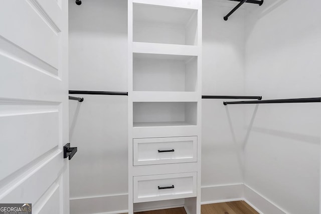 spacious closet featuring wood finished floors