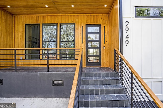 view of exterior entry featuring board and batten siding